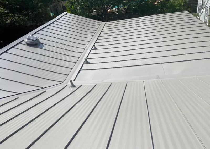 Solar attic fan installed on a metal roof for Roof Ventilation in Signal Hill