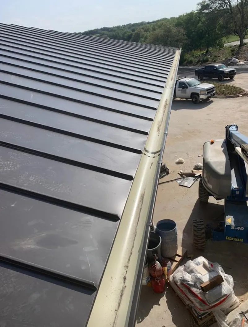 Standing seam panel and gutter detail on a metal roofing jobsite in Signal Hill